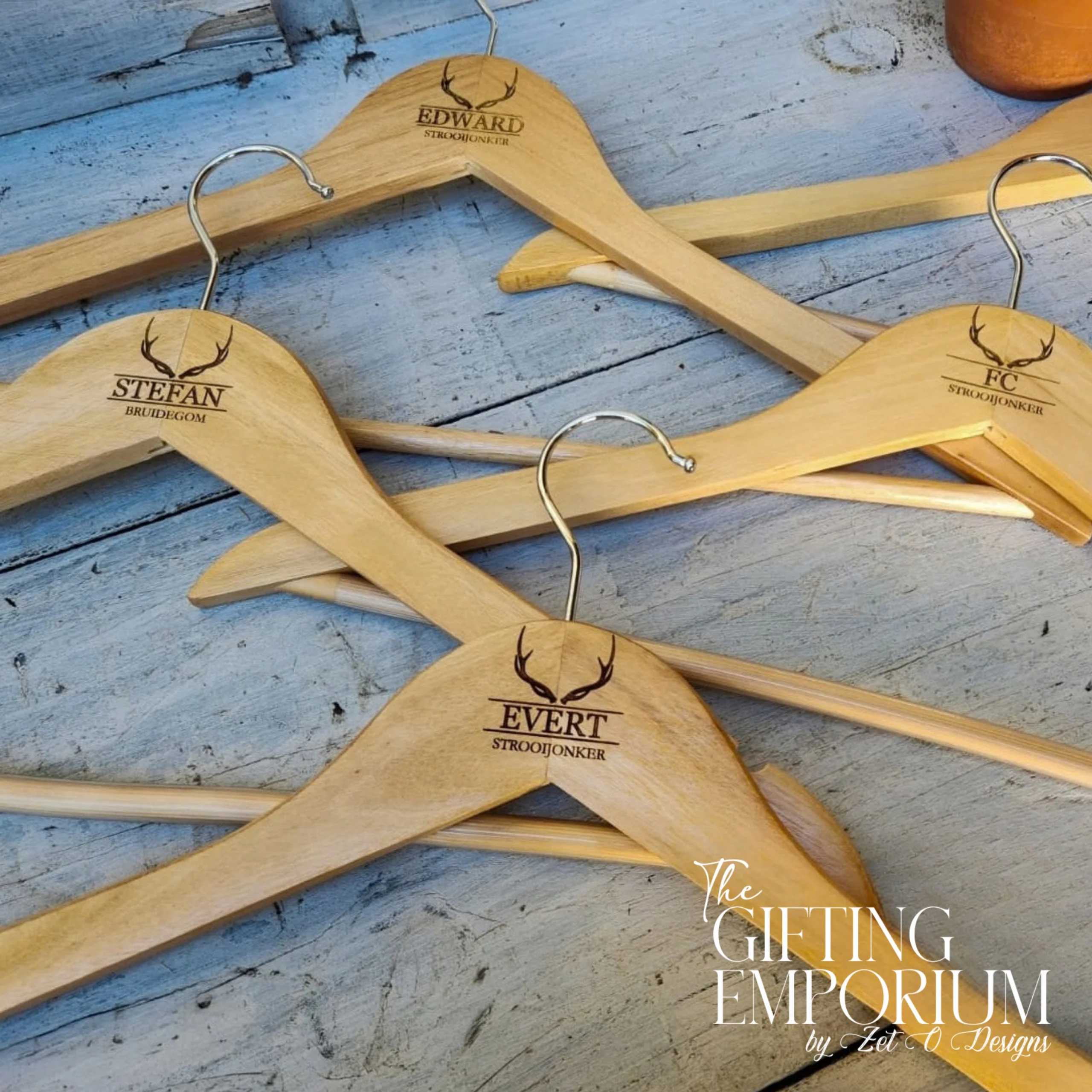 Wooden hanger with engraved buck horns motif, personalised for a wedding suit.