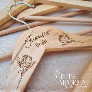 Personalised wooden wedding hanger with engraved protea motif